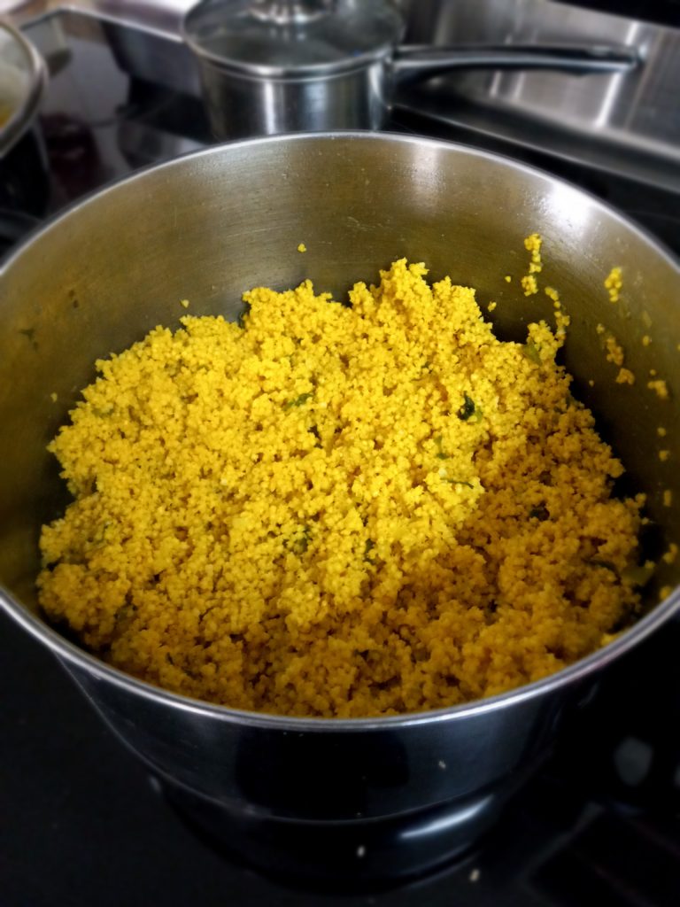 a pot of millet cooking on a stove