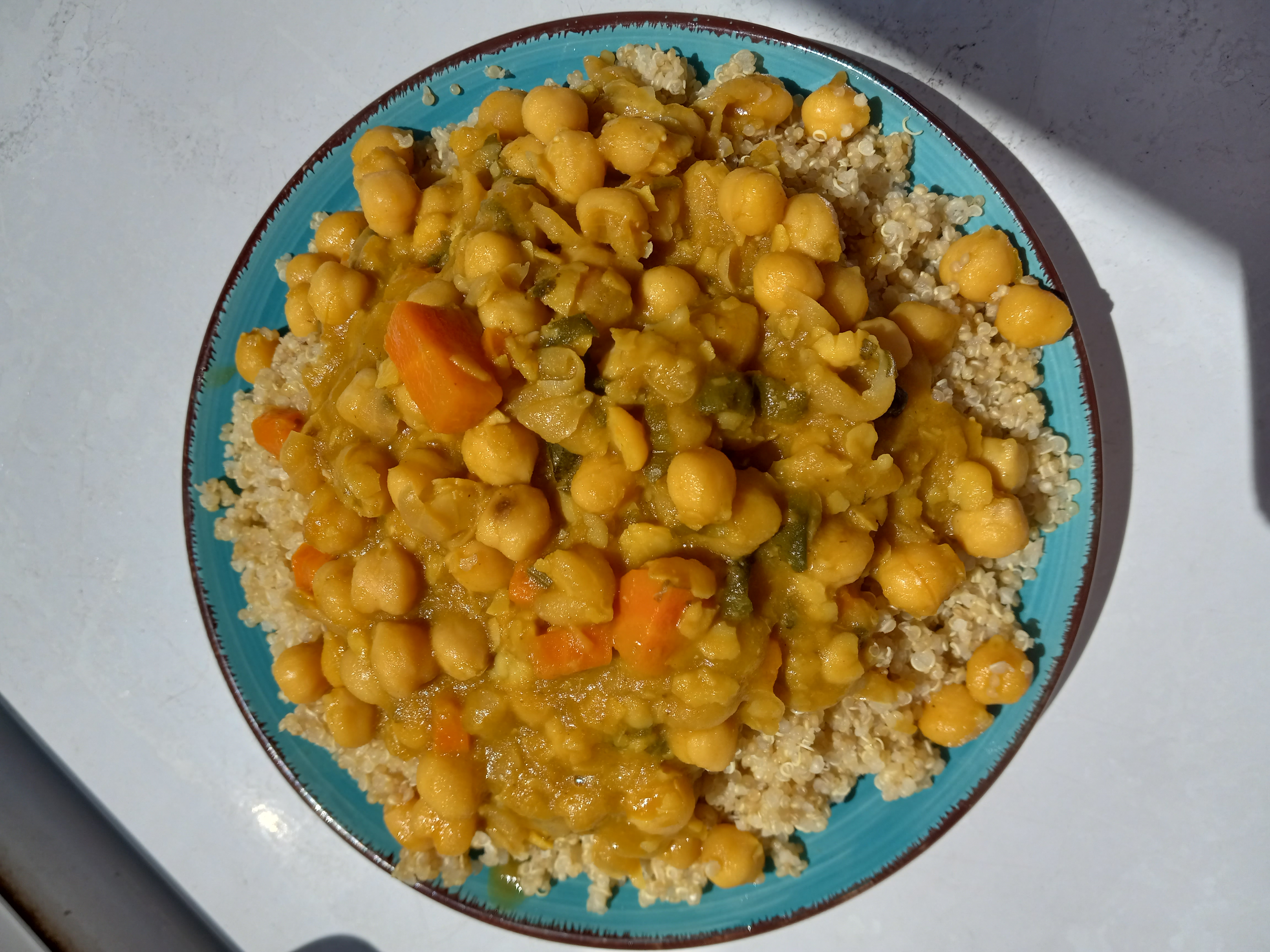 Overhead view of stewed chickpeas and quinoa.