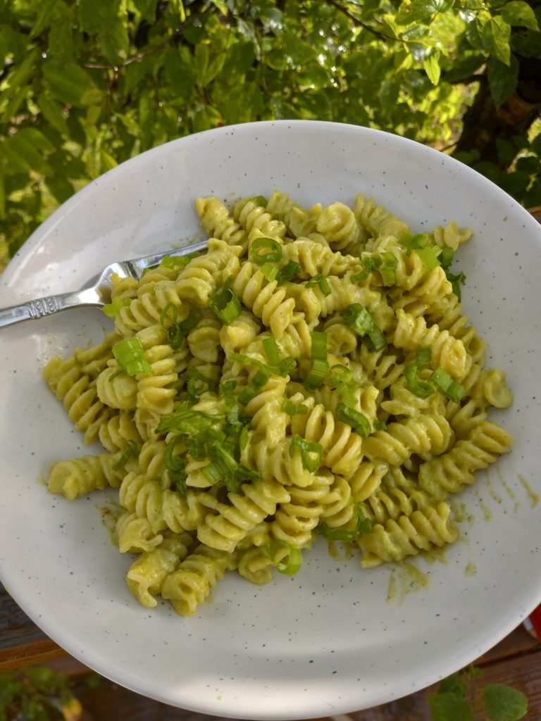 plate full of Creamy Avocado Pasta w/ Tahini and Green Onions