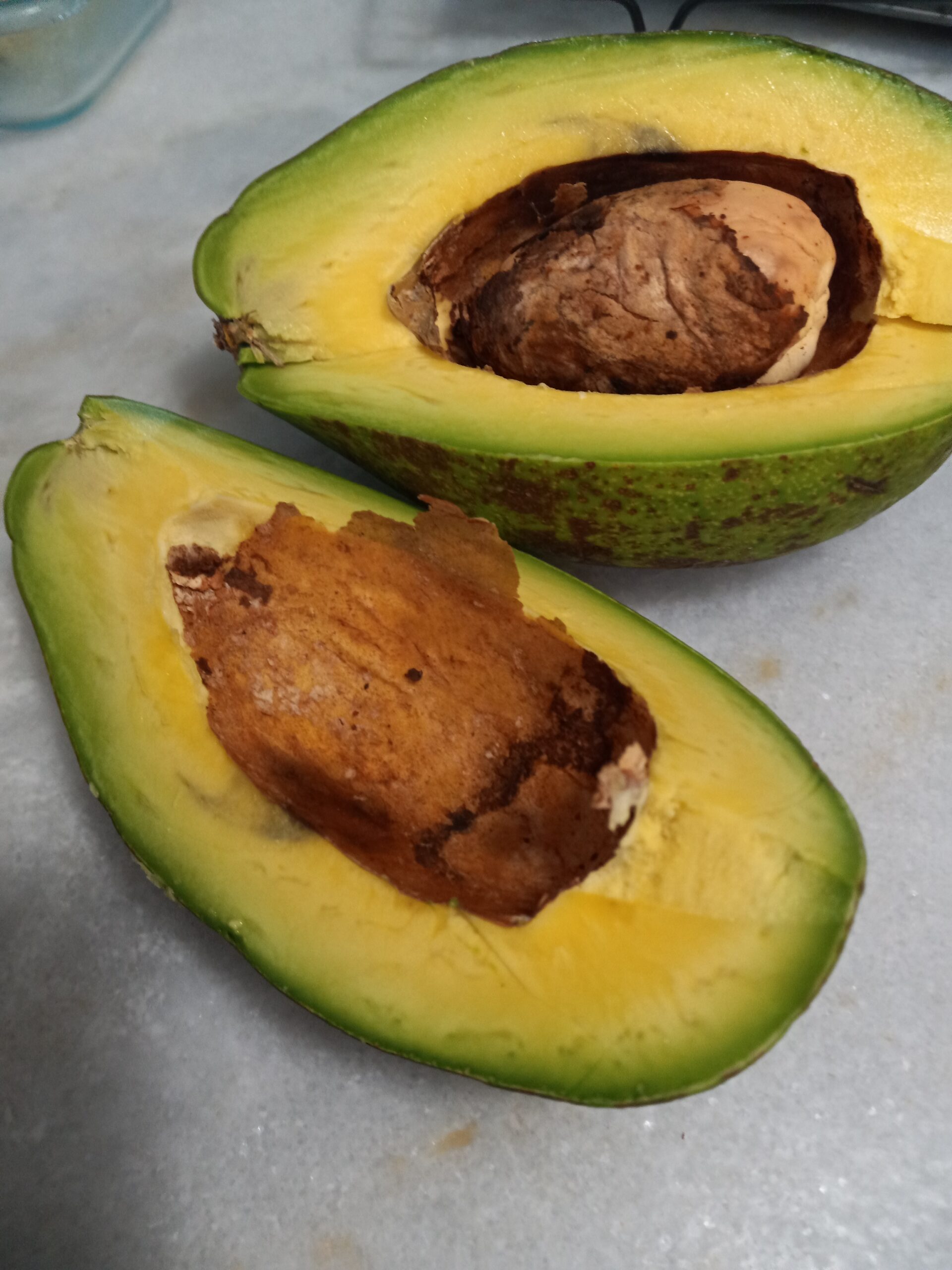 cut avocado on a marble table 