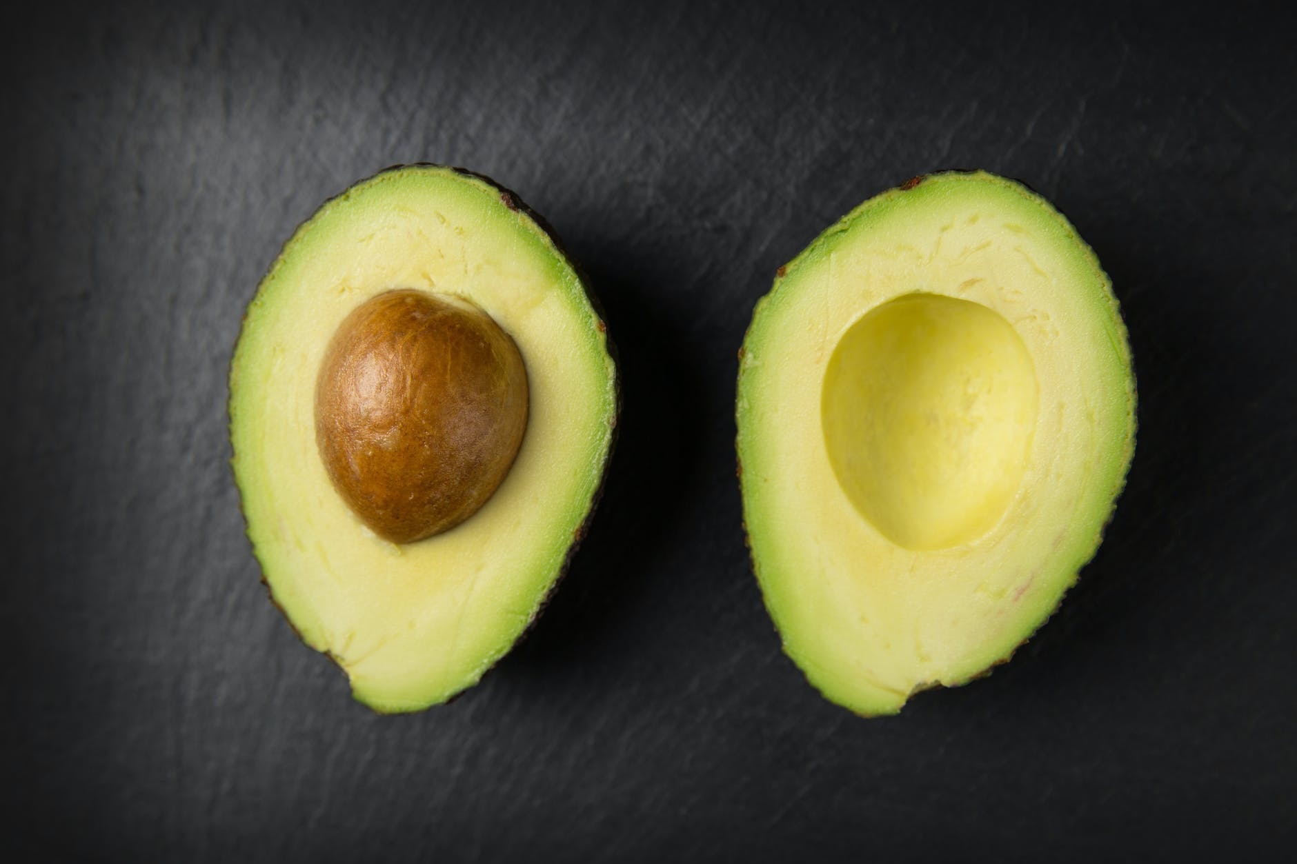 sliced avocado fruit on a black background