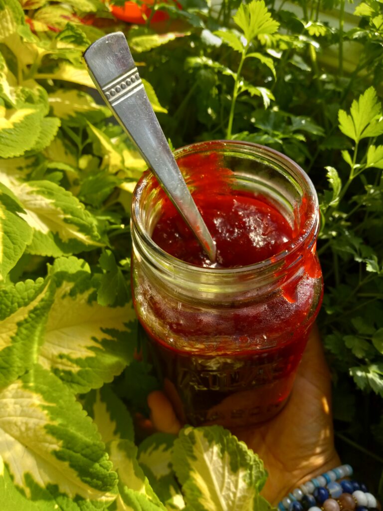 overhead shot of a glass jar of cranberry cinnamon jam