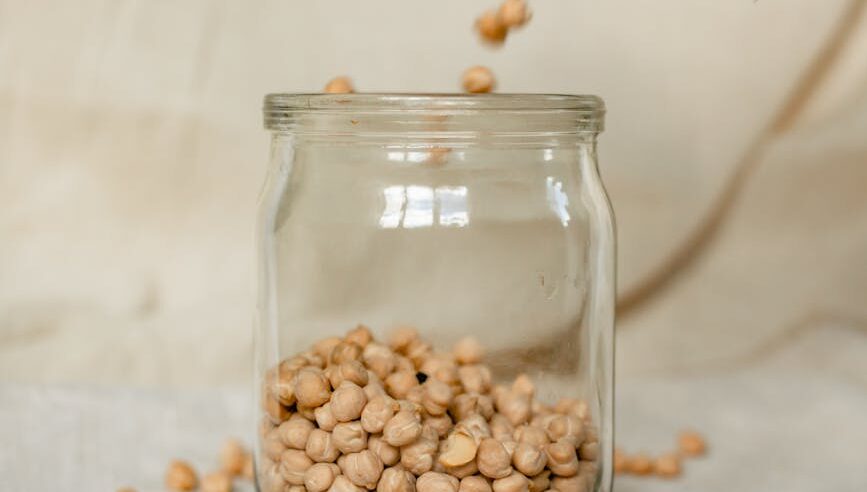 pouring dry chickpeas from a linen eco bag into a jar